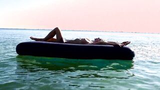 Curious Beach Day: Watch as a Stunning Blonde Enjoys the Sun with Dolphins Nearby!