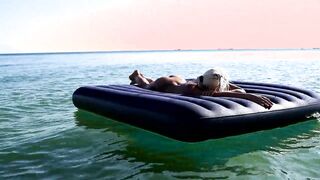I spy on the beach as a girl with big boobs sunbathes in front of the public and dolphins