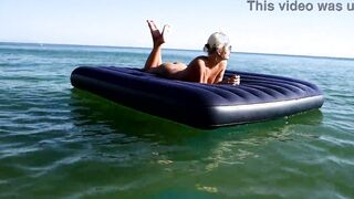 Curious Beach Day: Watch as a Stunning Blonde Enjoys the Sun with Dolphins Nearby!